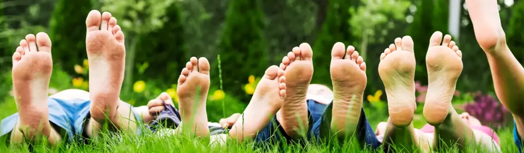 People lying in the grass experiencing lower stress levels